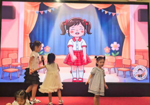 Các em nhỏ là con em cán bộ nhân viên VCC thích thú cầm micro ca hát và vui đùa trên sân khấu Ngày hội gia đình.